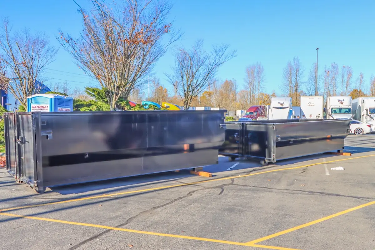 Professional dumpster rental service with roll-off container on residential driveway in Alvarado